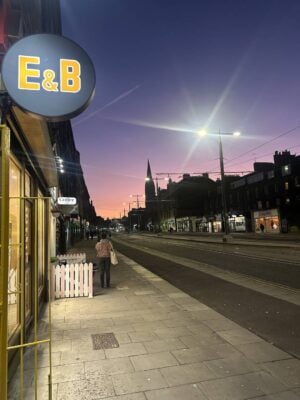 E&B sign with night sky and street beyond