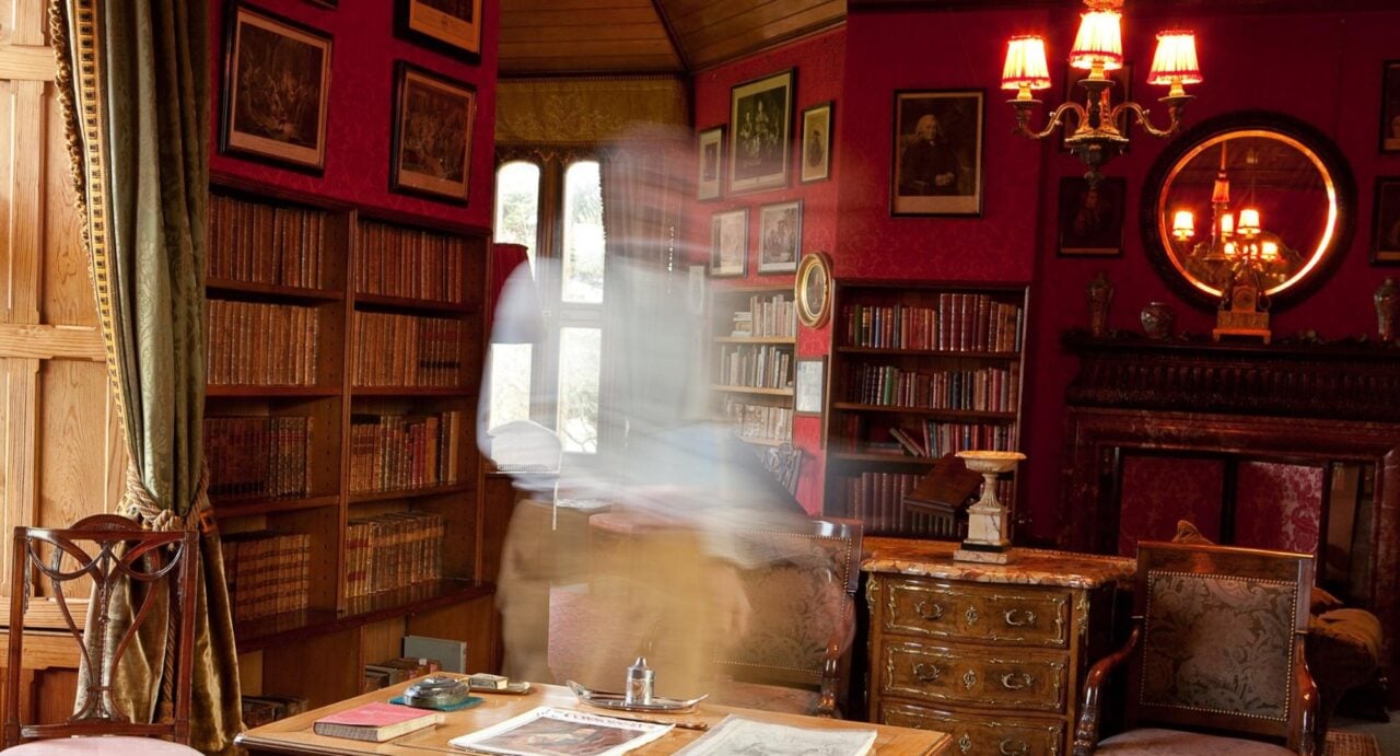 A ghost passing in front of the desk in the library at Lauriston Castle