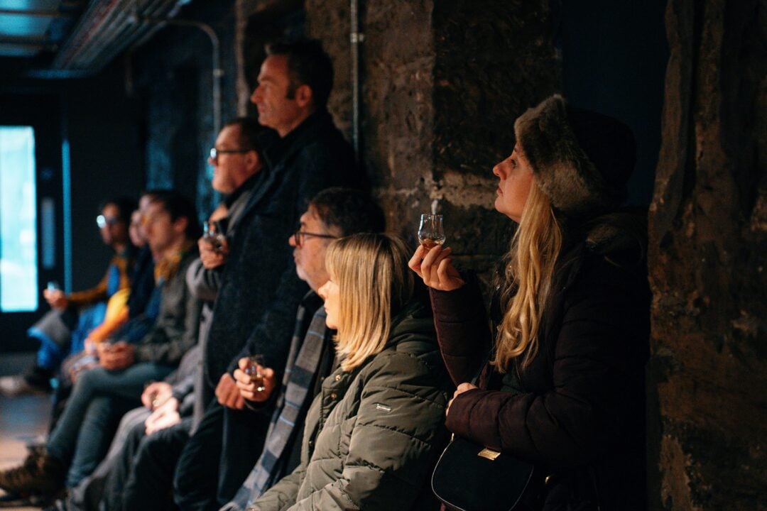 Crowd with whisky at Burns celebration at holyrood distillery