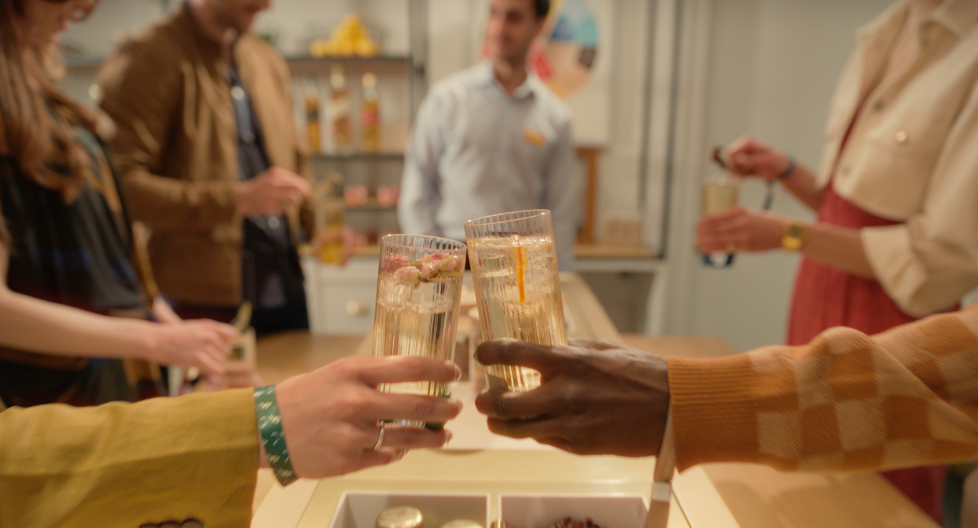 Two glasses with a Whisky cocktail being clinked together at Johnnie Walker Princes Street Tour of Flavour Tour.