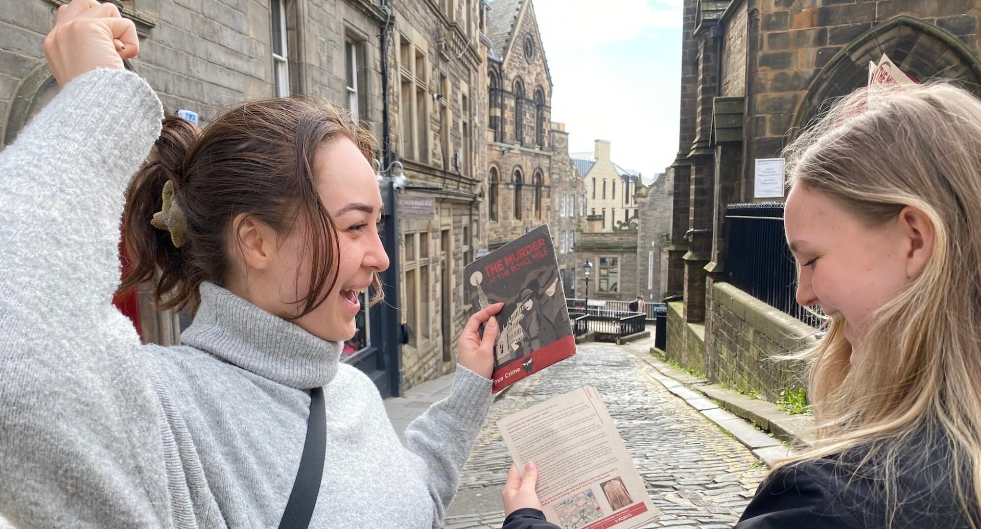 Two ladies holding a map on the Murder on the Royal Mile Tour