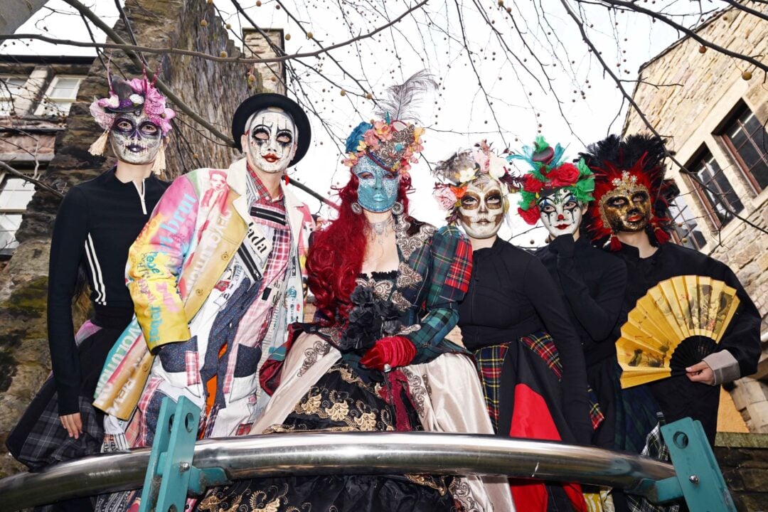 6 people wearing elaborate costumes and masks.