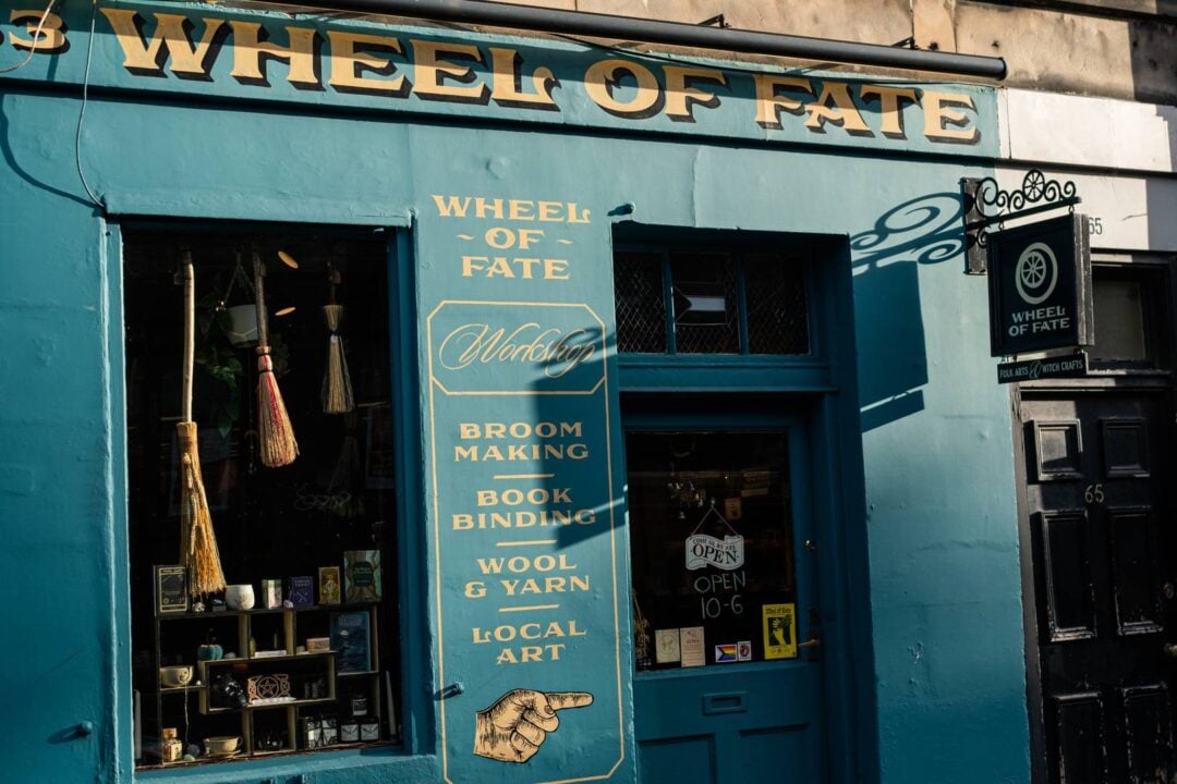 image of a blue shop with yellow text reading wheel of fate