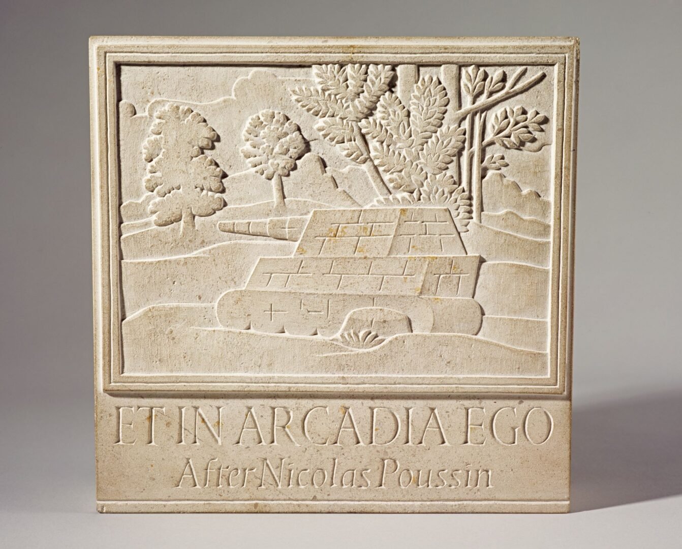 Stone carving showing a tank moving through forestry.