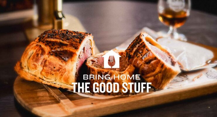 Beef, haggis and pancetta wellington with words The Good stuff home printed over image