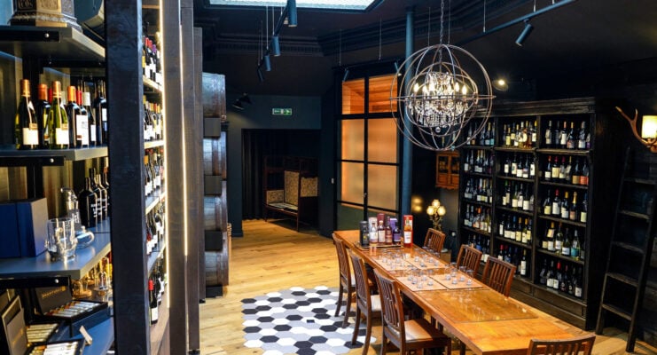 Interior of shop, with shelves filled with bottles.