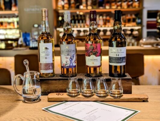 Bottles of Whisky and Glasses lined up for Glenkinchie Flight Club tasting event