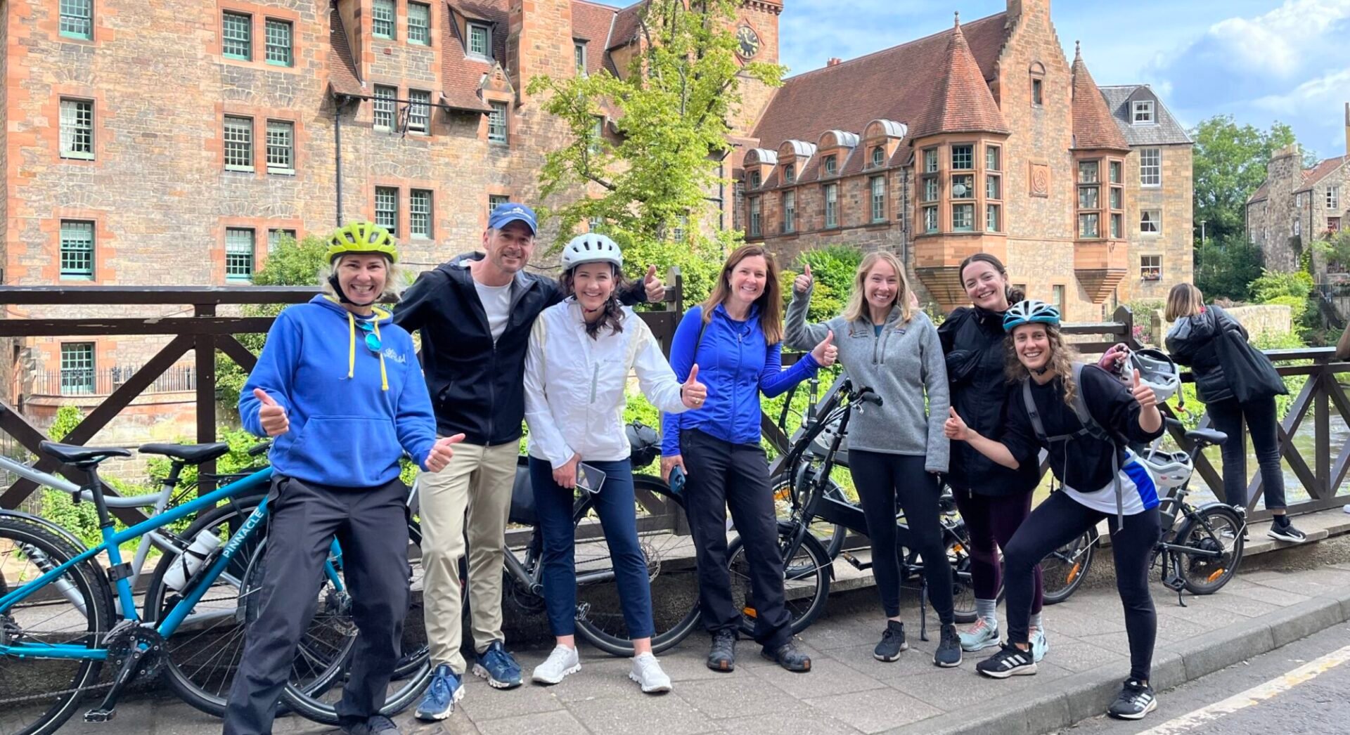 A group of cyclists on Dean bridge with Dean Village in the background