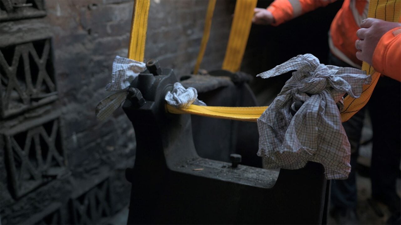 Close-up of engine being held in a harness.