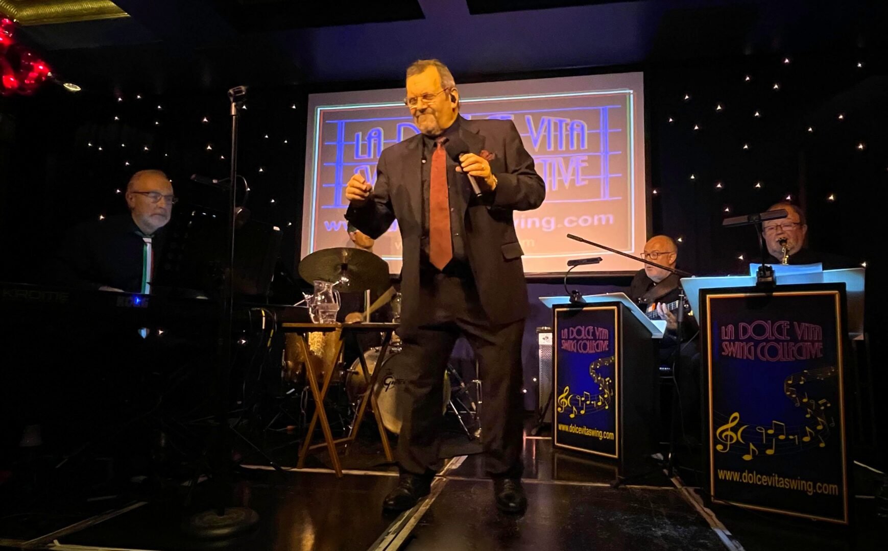 Older man dancing on a stage