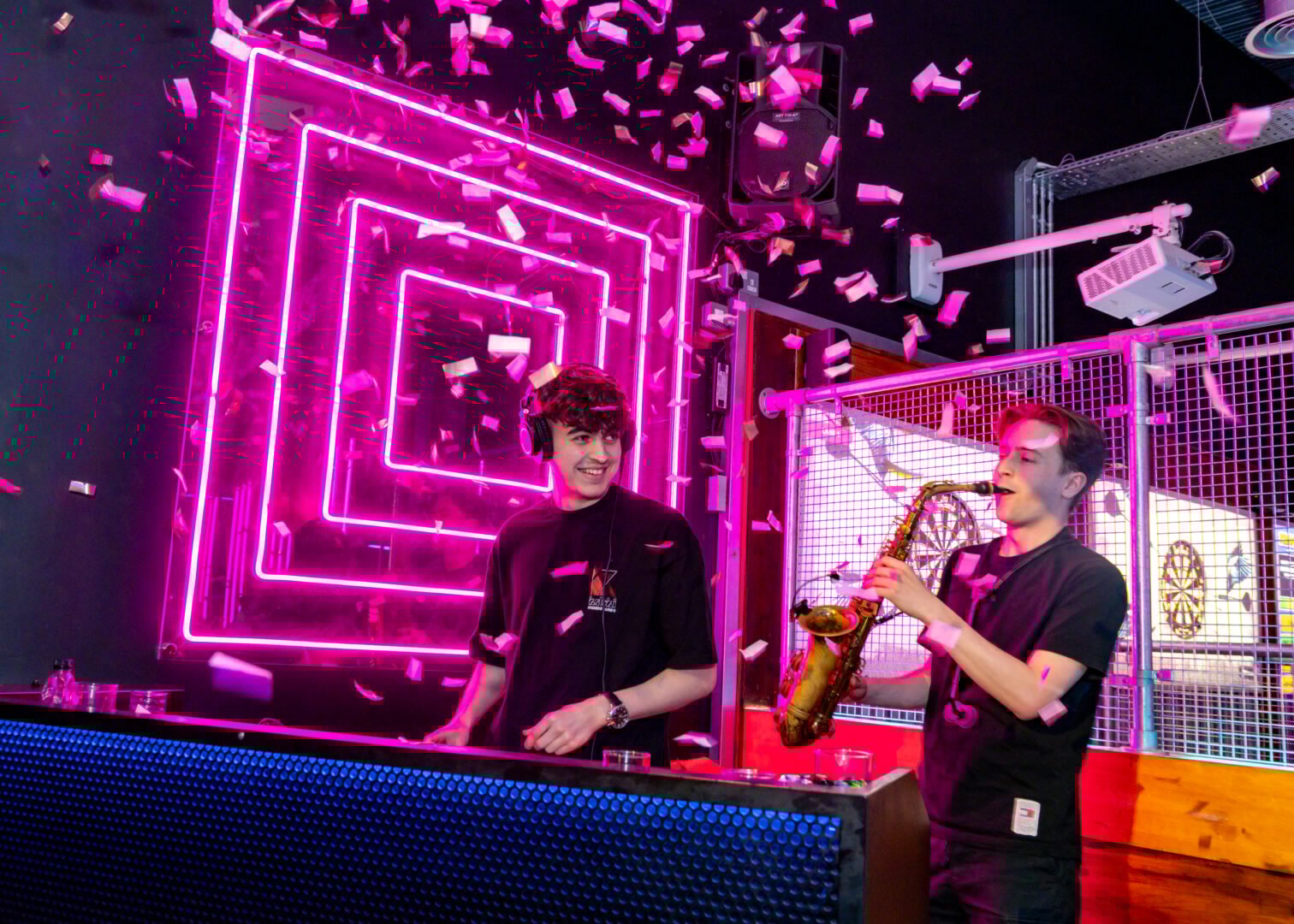 DJ and a saxophone player at Boom Battle Bar