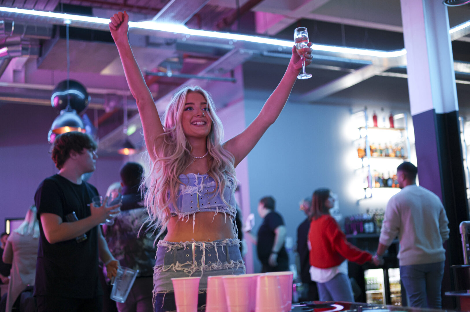 Girl playing Prosecco Pong at Boom Battle Bar