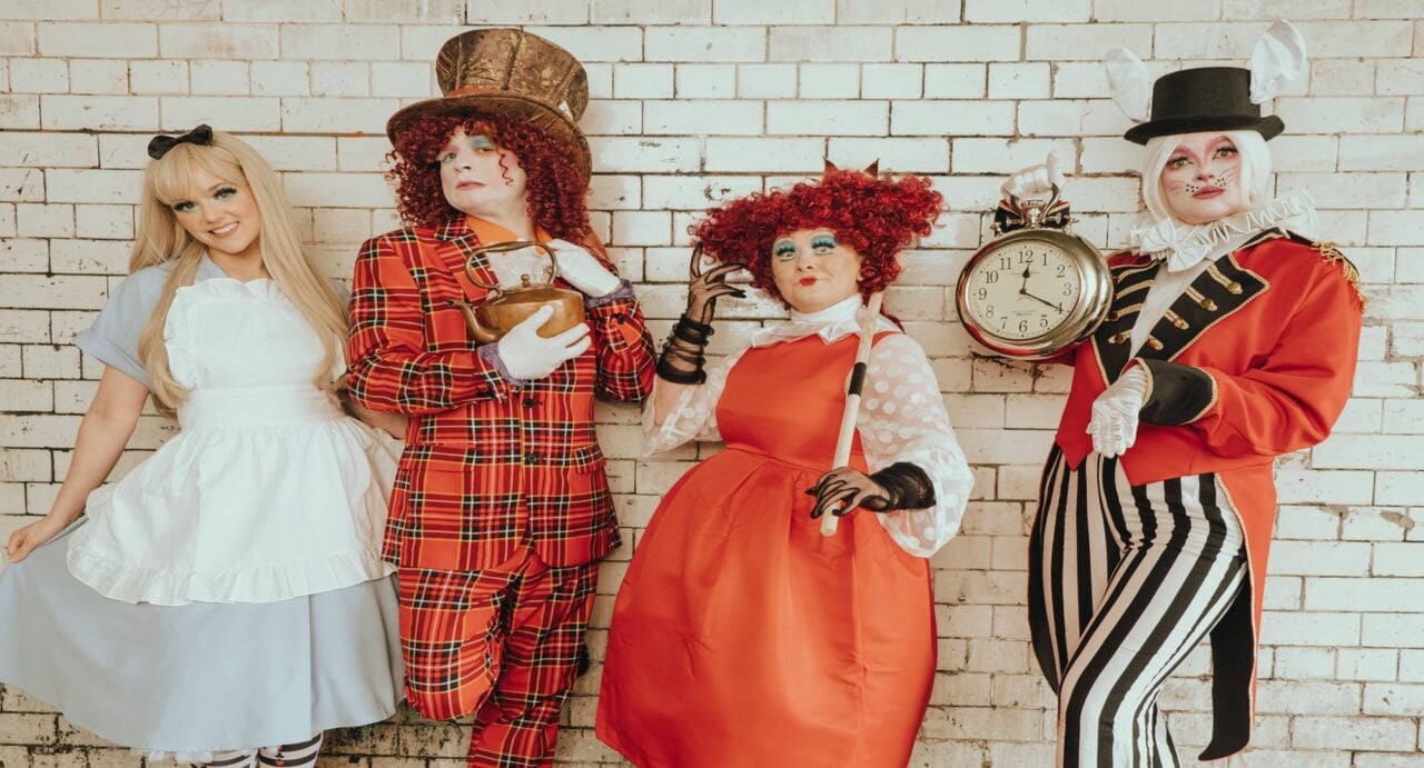 Four people dressed up as characters from Alice in Wonderland