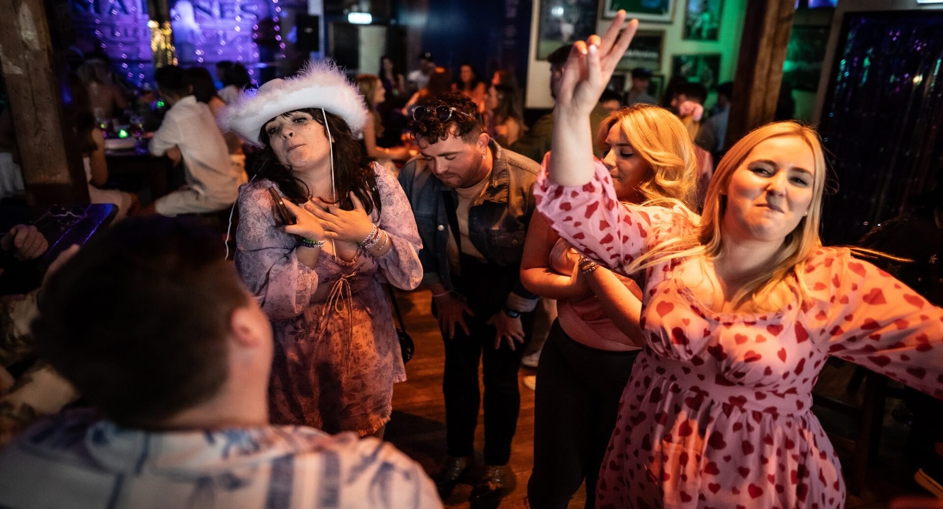 Three women and a man dancing