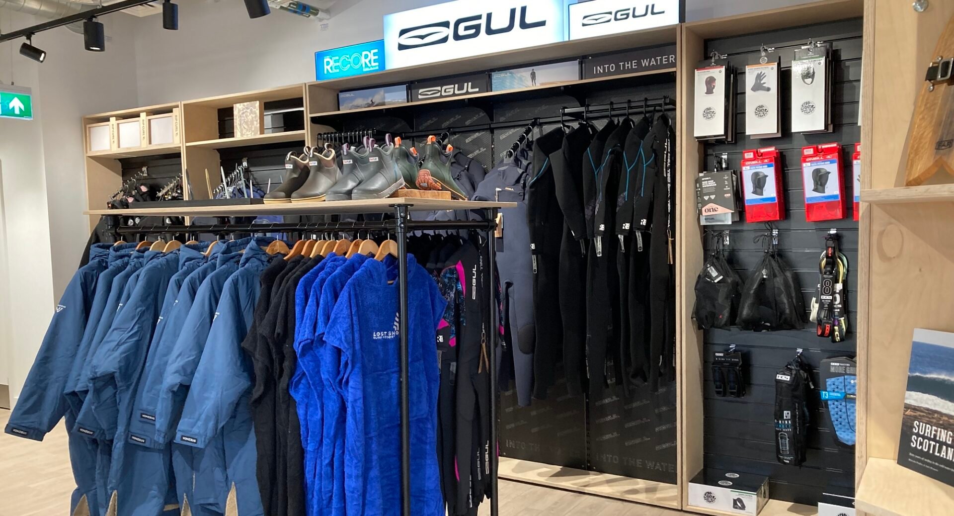 Interior of the surf shop at Lost Shore showing Wet suits, Boots and Dry Robes