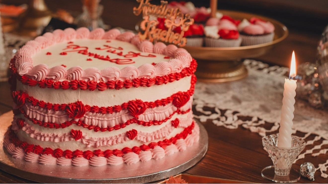 Pink cake with writing on it saying just married from Krema Bakehouse