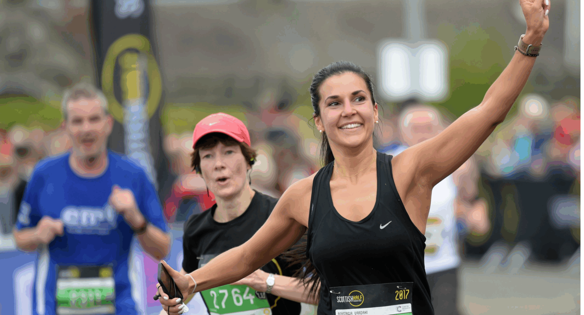 Group of runners, with a smiling woman in front.