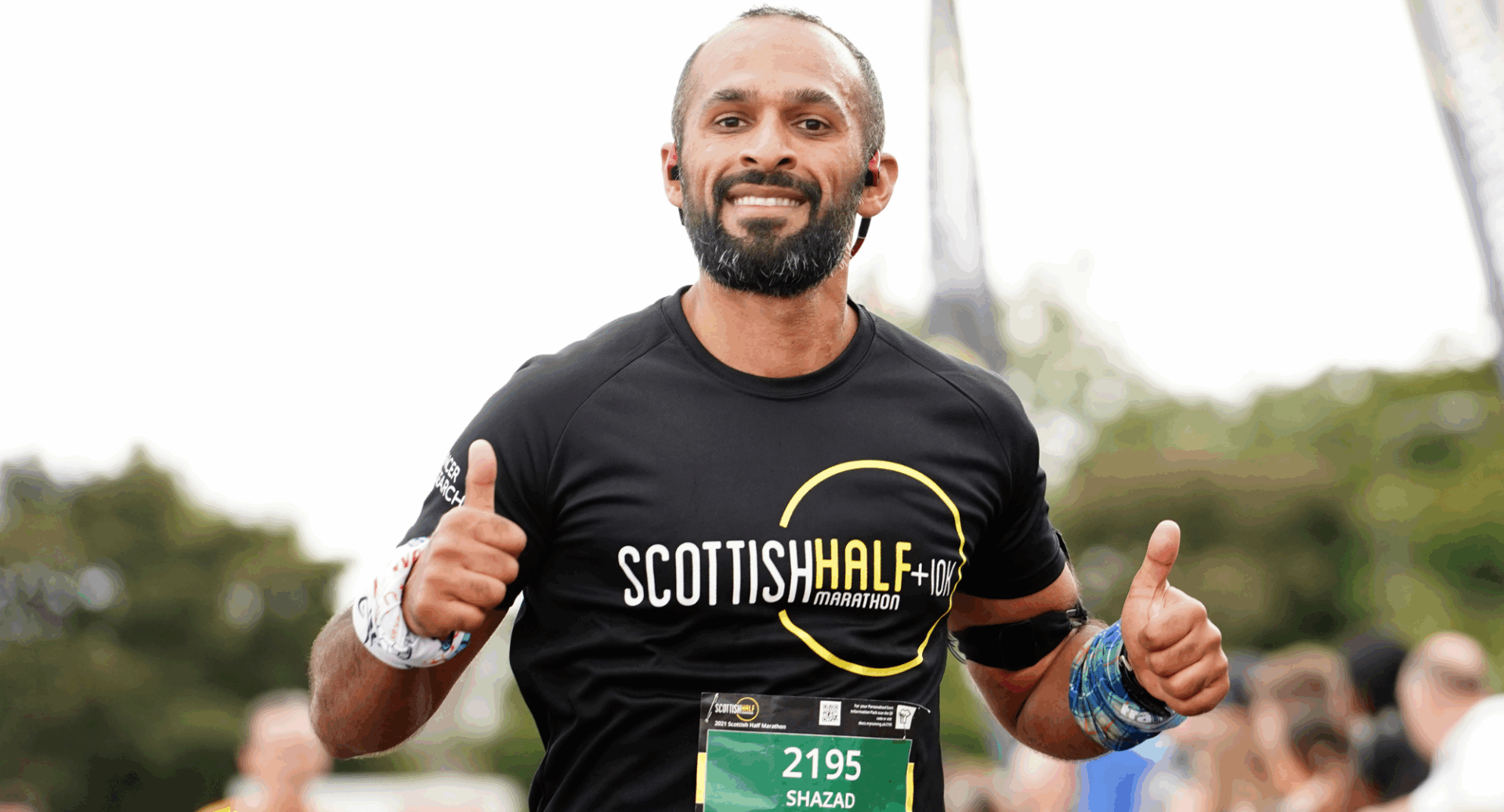 Man running, giving a thumbs up signal.
