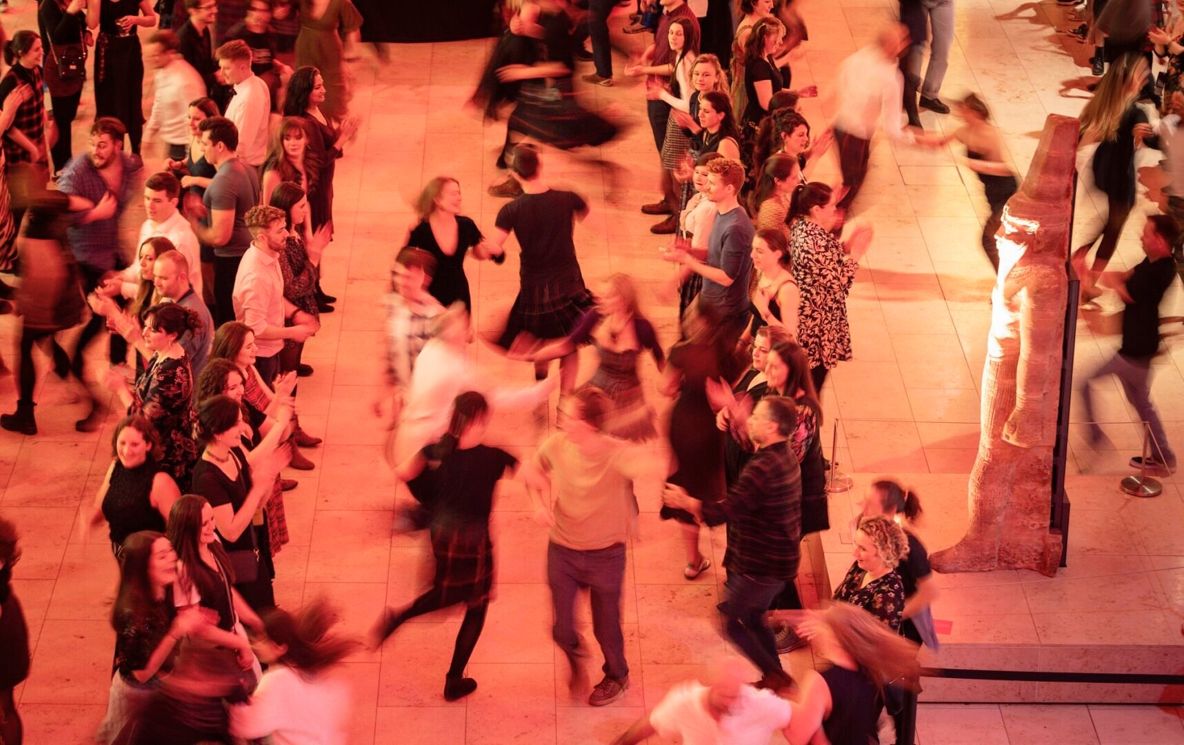 People ceilidh dancing at museum late at national museum of scotland