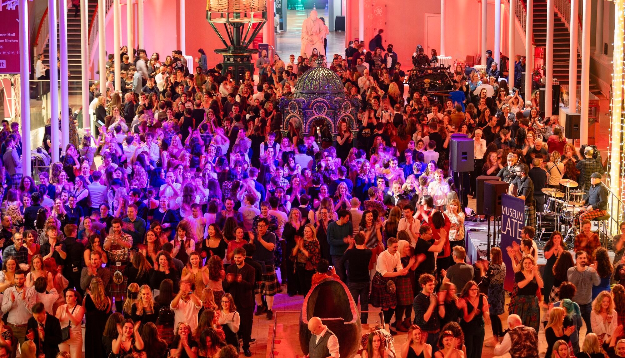 Large group of people ceilidh dancing at the National Museum for Scotland's Museum lates