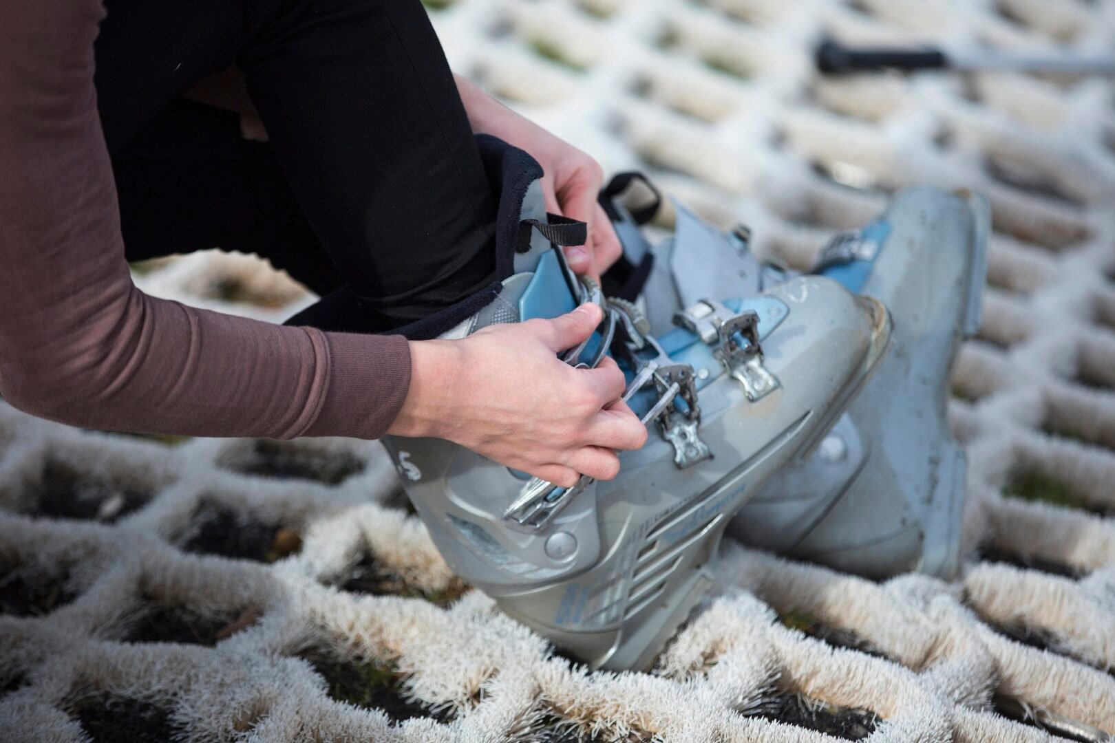 Person putting on Ski Boots on the dry ski slope