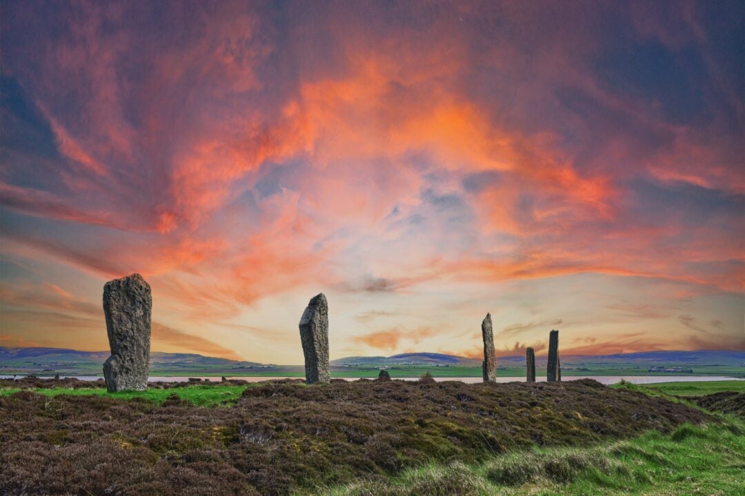 Standing stones against a red sky