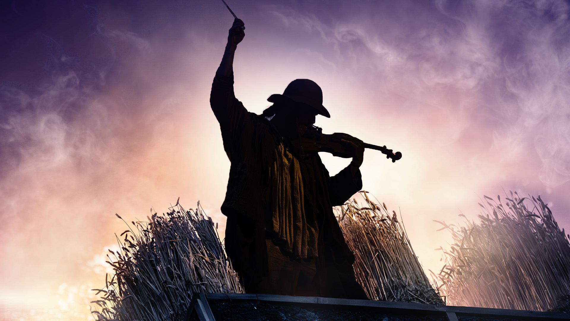 Silhouette of person playing a fiddle against a light purple sky.
