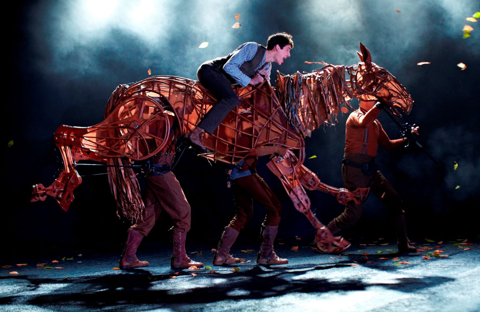 Man riding a puppet horse.