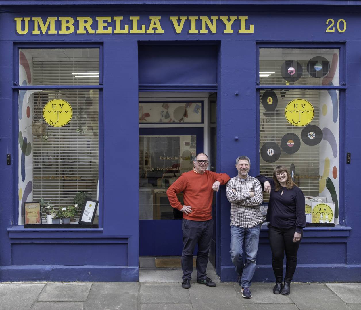 Umbrella Vinyl shop owners Josh, Nick & Laura standing in front of the shop.