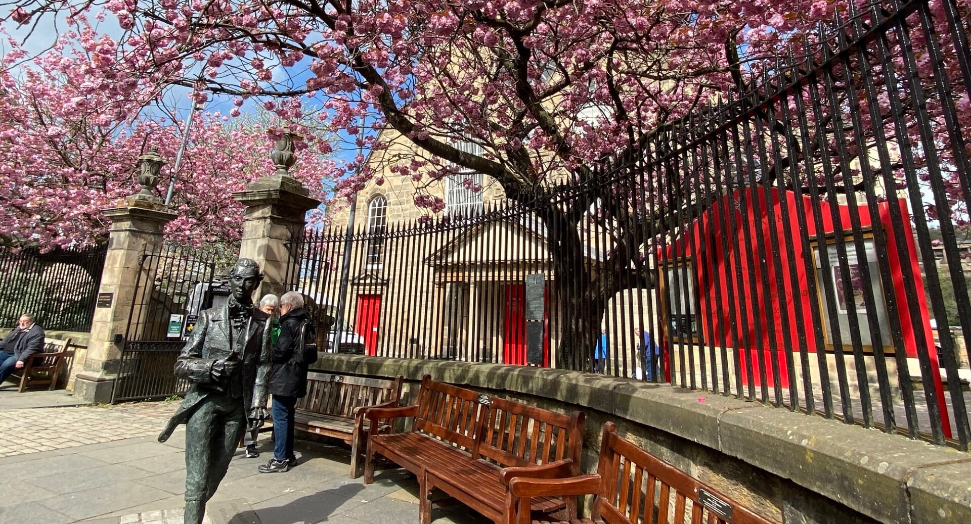Statue of Robert Fergusson outside Canongate Kirk with Spring Blossom