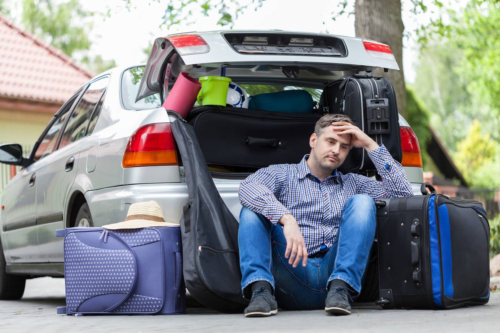 AiroLuggage man at boot of car with luggage around him