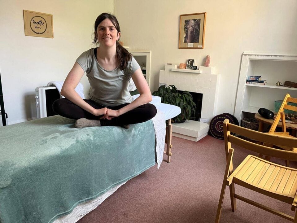 Jo  who does Massage Therapy sitting on massage bed