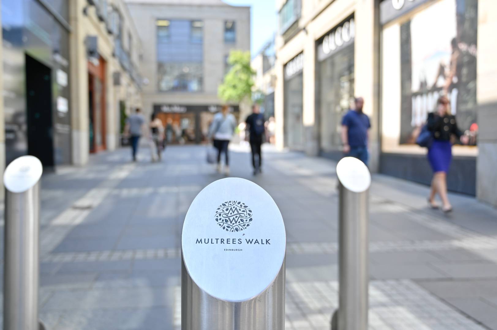 Multrees Walk walkway with Multrees Walk  logo embossed on metal bollard,© Multrees Walk