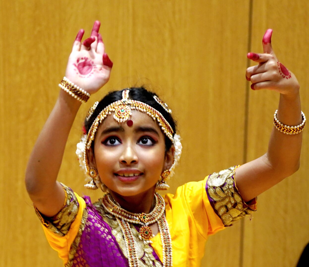 A head and shoulders shot of Mohul, a young girl dancing in traditional Indian clothes