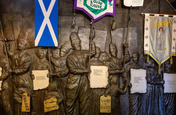 A stone sculpture showing protestors