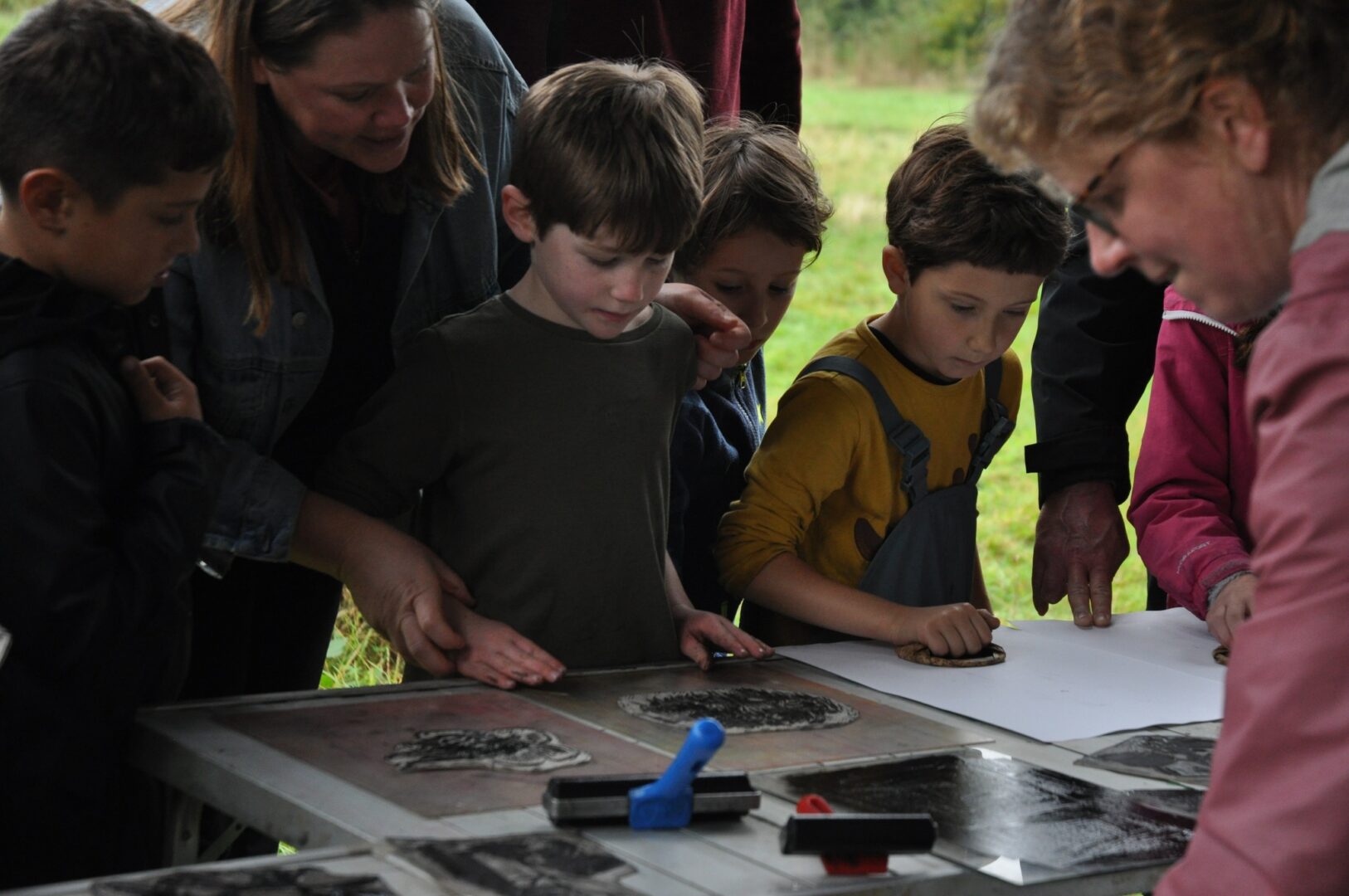 Children poring over a table with art materials on it at an ELGT event