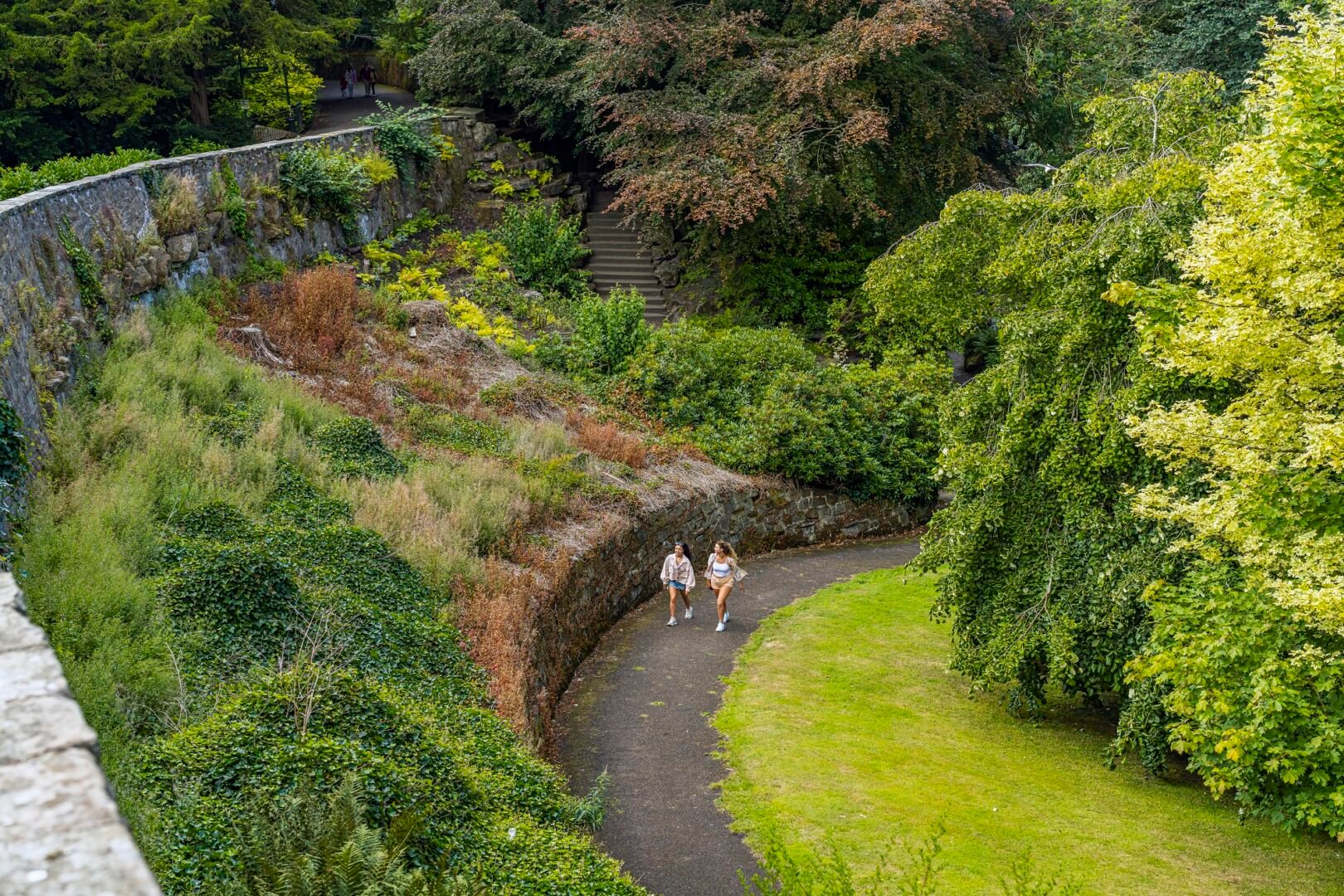 two people walking in the distance in the grounds of Pittencrieff Park