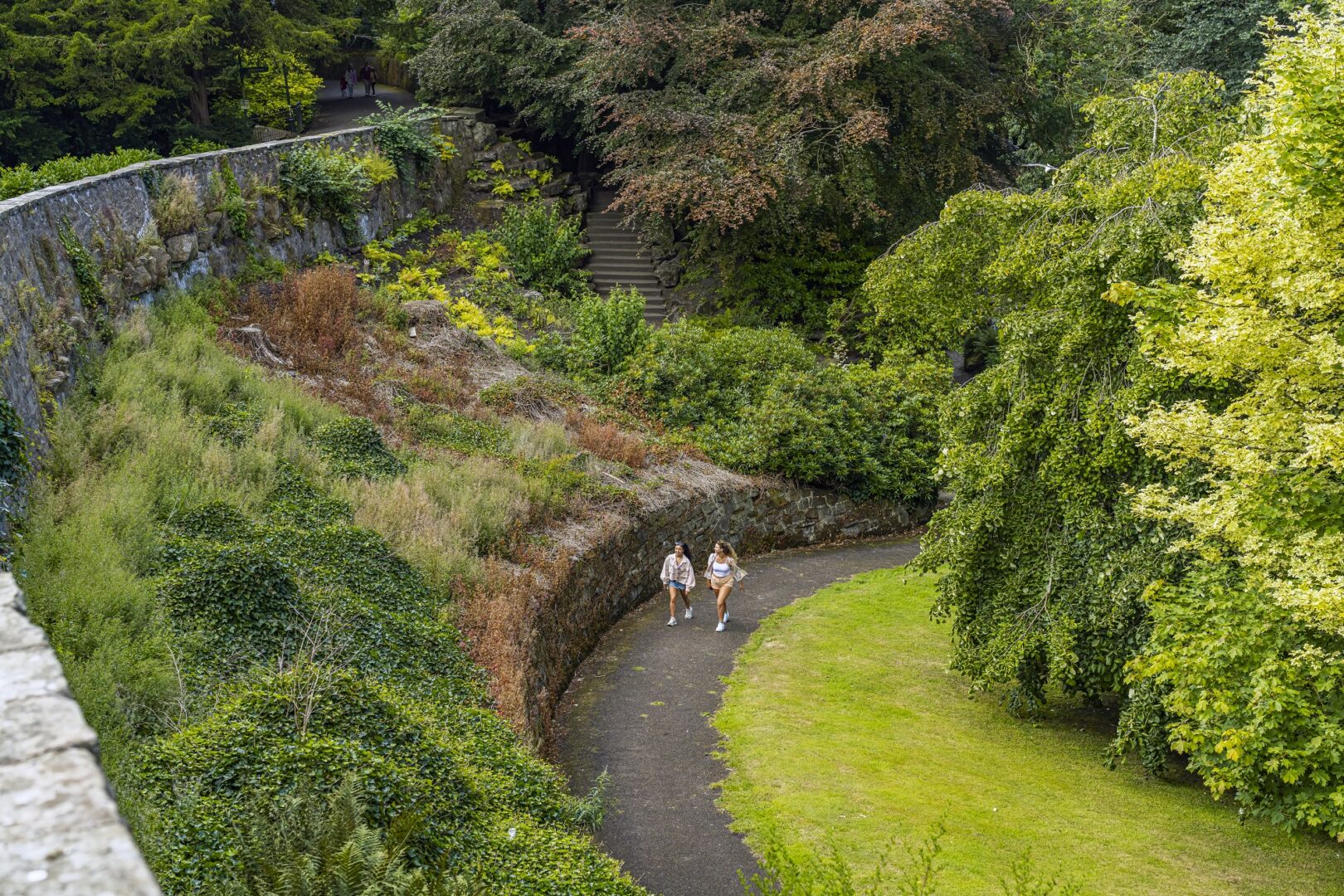 two people walking in the distance in the grounds of Pittencrieff Park