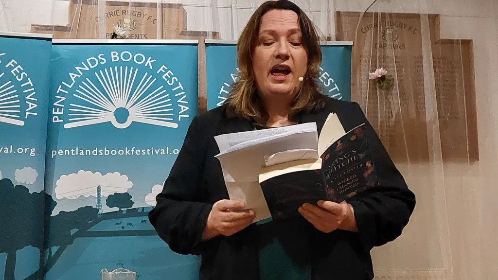 A woman reading a book to an audience