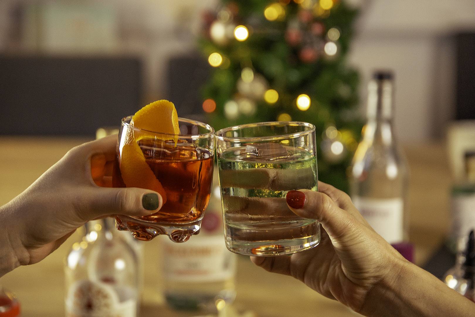 Two glasses of gin being cheered together