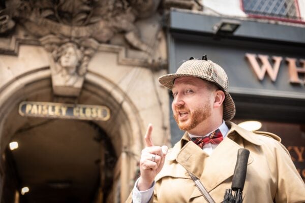 Tour Guide standing outside PAisley Close