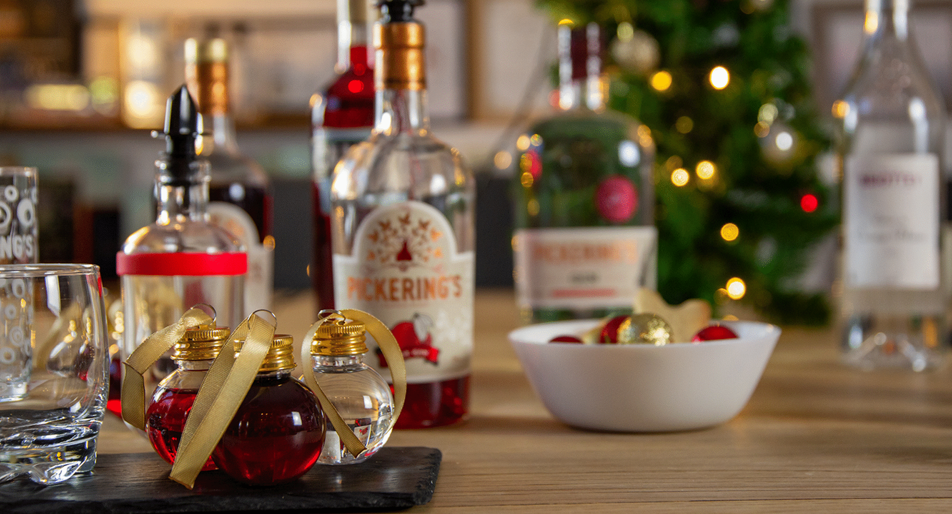Pickering's Gin baubles with a Christmas decoration and Gin bottle in background
