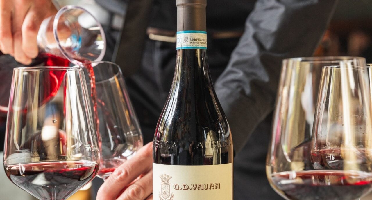 Close-up of a bottle of red wine and glasses.