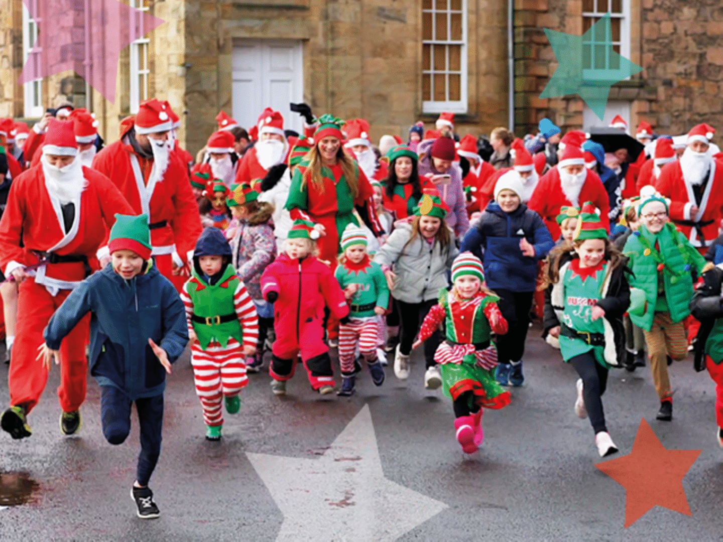 A group of adults and young children, dressed in Santa and elf costumes.