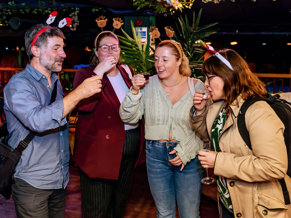 A group of adults playing Christmas games