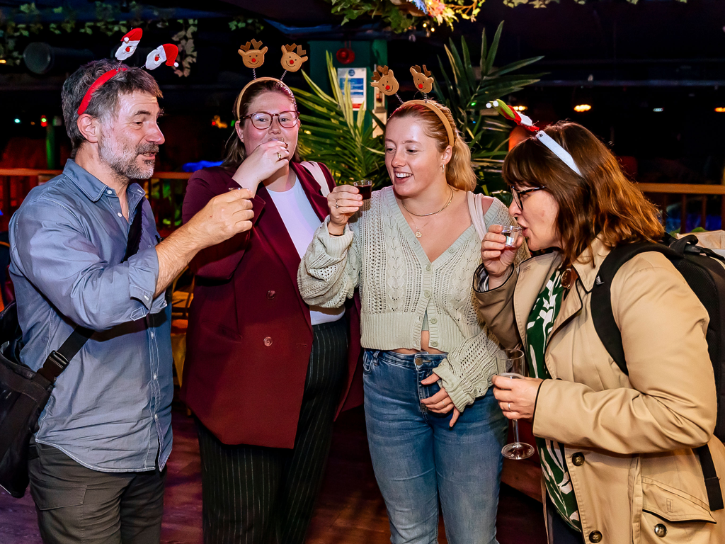 A group of adults playing Christmas games
