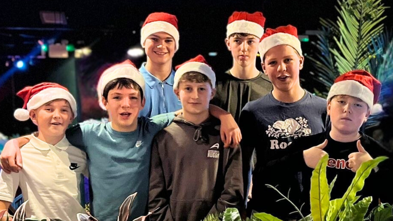 A group of kids with Santa hats on