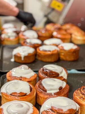 Our pastry chef preparing our signature individual baked buns, made fresh in cinnamon, pistachio and seasonal flavours.