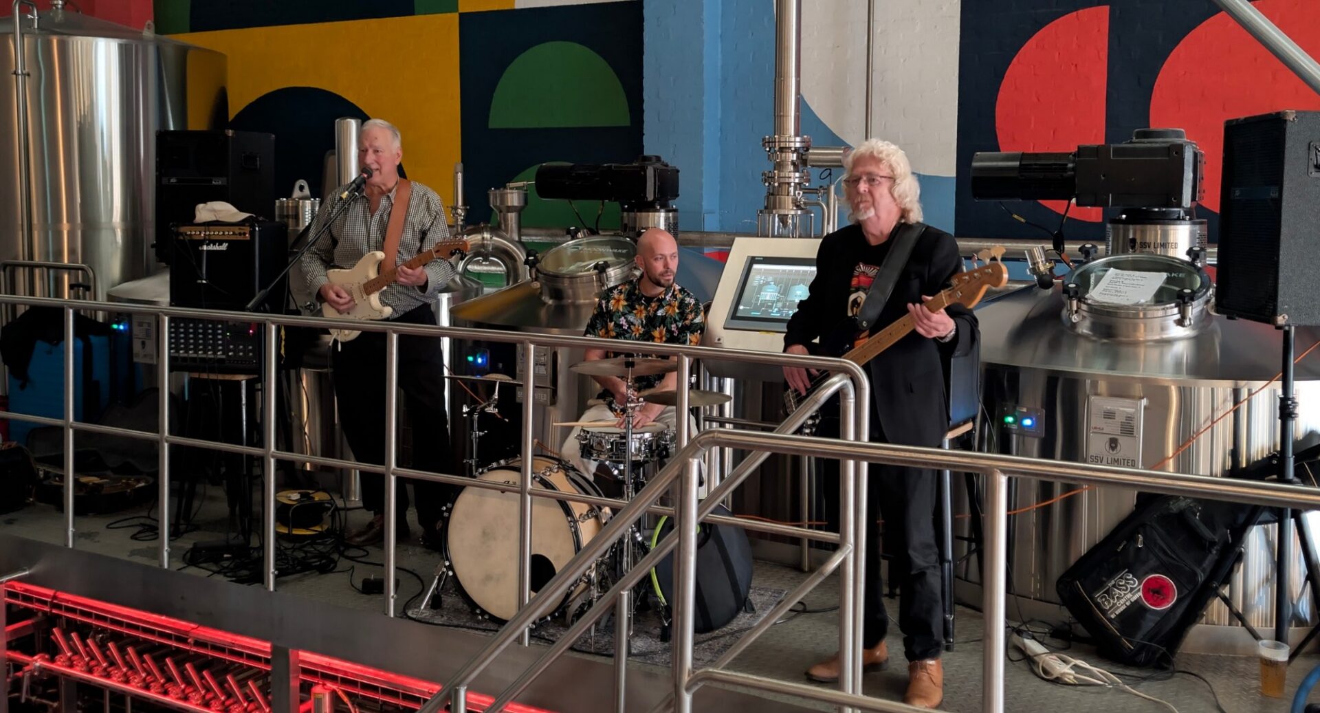 3-piece band performing on a stage.