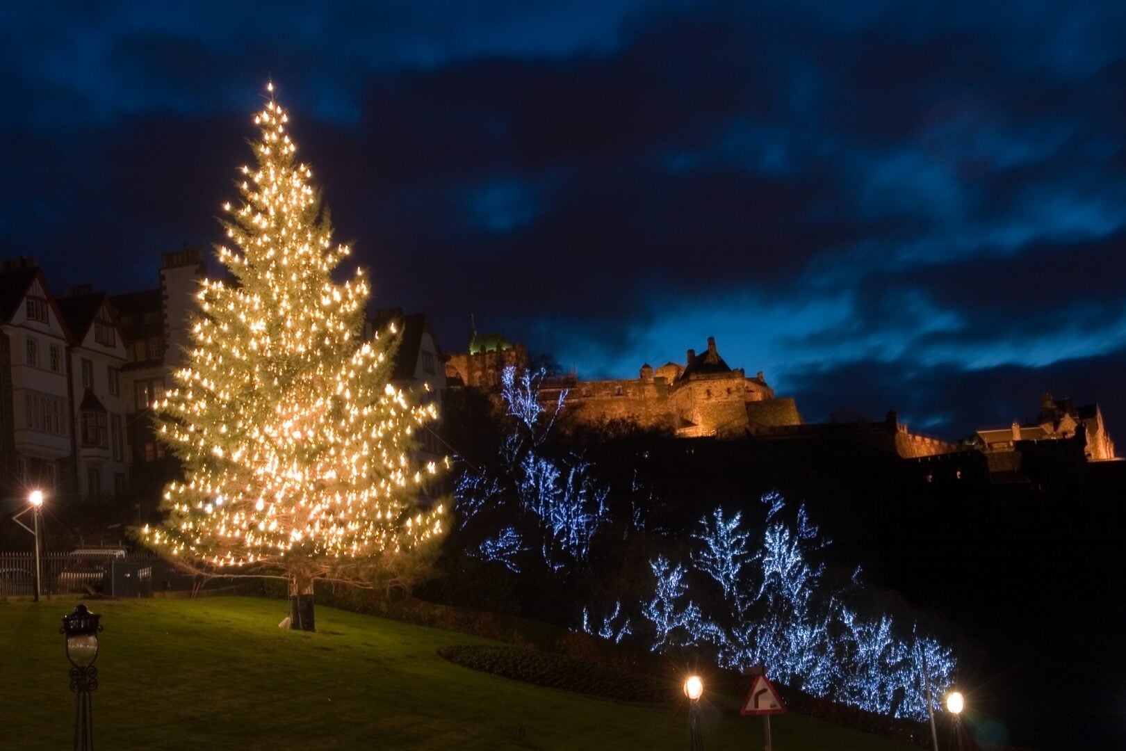 Christmas Tree lit up on the mound with Edinburgh Castle in background